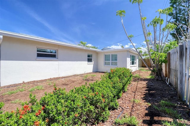 1897 Dolphin Blvd S, Saint Petersburg, FL 33707 - rear view of property featuring stucco siding and a fenced backyard