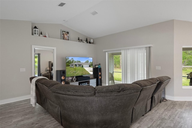 16473 Scaup Duck Ave, Weeki Wachee, FL 34614 - living room with vaulted ceiling, light wood-type flooring, and baseboards