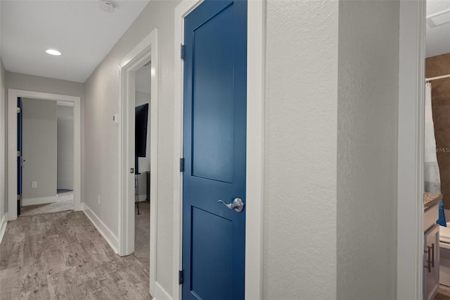 16473 Scaup Duck Ave, Weeki Wachee, FL 34614 - hall featuring light wood-style flooring, baseboards, and recessed lighting
