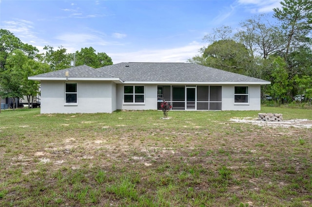 16473 Scaup Duck Ave, Weeki Wachee, FL 34614 - back of property with stucco siding, a yard, a sunroom, and a shingled roof