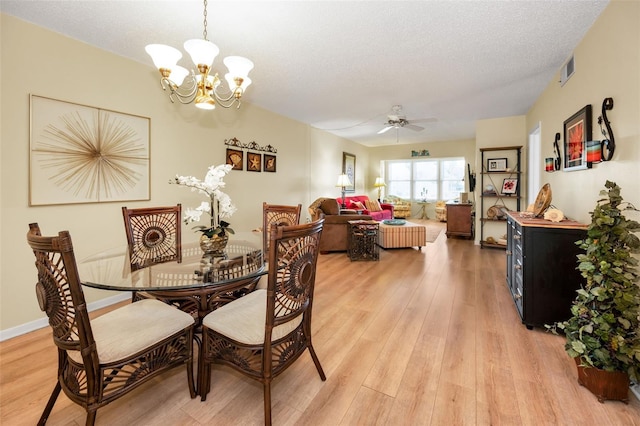 960 Virginia St Unit 202, Dunedin, FL 34698 - dining room featuring a chandelier, light wood-type flooring, ceiling fan, and a textured ceiling