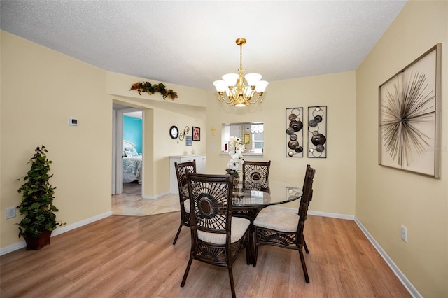 960 Virginia St Unit 202, Dunedin, FL 34698 - dining area with a chandelier and light wood-style flooring