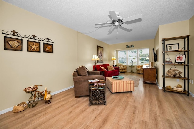 960 Virginia St Unit 202, Dunedin, FL 34698 - living area featuring light wood finished floors, a textured ceiling, and ceiling fan