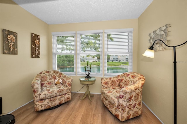 960 Virginia St Unit 202, Dunedin, FL 34698 - sitting room with wood finished floors and a textured ceiling