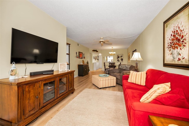 960 Virginia St Unit 202, Dunedin, FL 34698 - living area with light wood-type flooring, a chandelier, a textured ceiling, and a ceiling fan