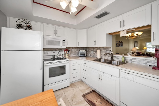 960 Virginia St Unit 202, Dunedin, FL 34698 - kitchen with white appliances, light countertops, a chandelier, tasteful backsplash, and a ceiling fan