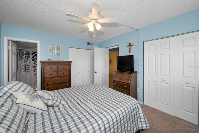 960 Virginia St Unit 202, Dunedin, FL 34698 - bedroom with two closets, carpet, a textured ceiling, and ceiling fan