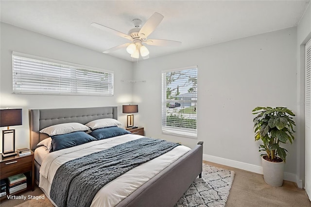 3121 Egret Ter, Safety Harbor, FL 34695 - carpeted bedroom featuring multiple windows, baseboards, and a ceiling fan