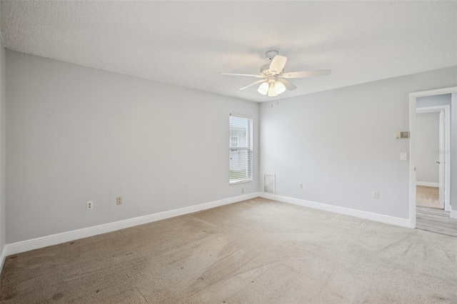 3121 Egret Ter, Safety Harbor, FL 34695 - unfurnished room featuring a ceiling fan, light carpet, baseboards, and a textured ceiling
