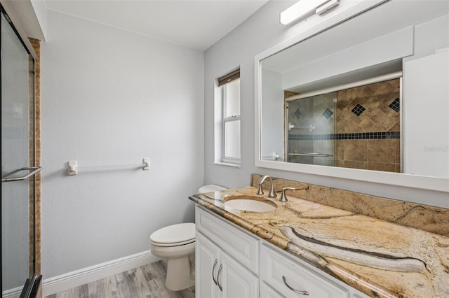 3121 Egret Ter, Safety Harbor, FL 34695 - full bathroom featuring vanity, a stall shower, toilet, wood finished floors, and baseboards