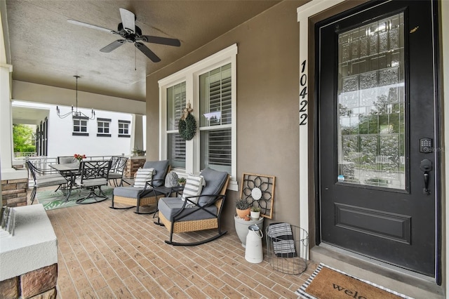 10422 Fenceline Rd, New Port Richey, FL 34655 - covered porch featuring ceiling fan and outdoor dining area