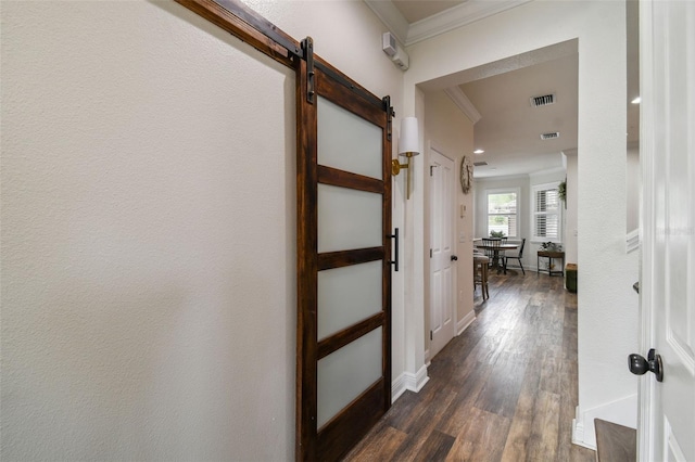 10422 Fenceline Rd, New Port Richey, FL 34655 - hall with a barn door, crown molding, dark wood-type flooring, and baseboards