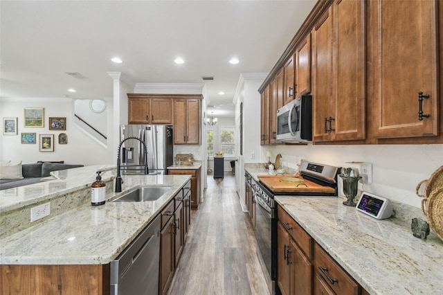 10422 Fenceline Rd, New Port Richey, FL 34655 - kitchen featuring stainless steel appliances, wood finished floors, light stone countertops, recessed lighting, and a sink