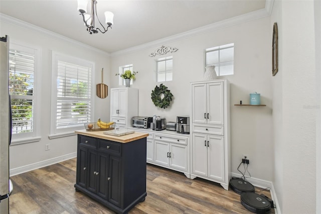 10422 Fenceline Rd, New Port Richey, FL 34655 - kitchen with wooden counters, ornamental molding, white cabinetry, plenty of natural light, and dark wood-style floors