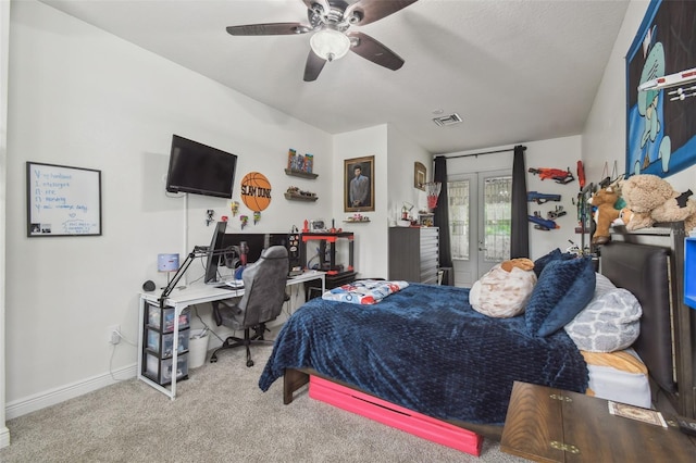 10422 Fenceline Rd, New Port Richey, FL 34655 - bedroom with an office area, carpet floors, a ceiling fan, and baseboards