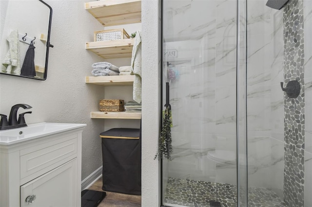 10422 Fenceline Rd, New Port Richey, FL 34655 - full bath with a stall shower, vanity, wood finished floors, and baseboards