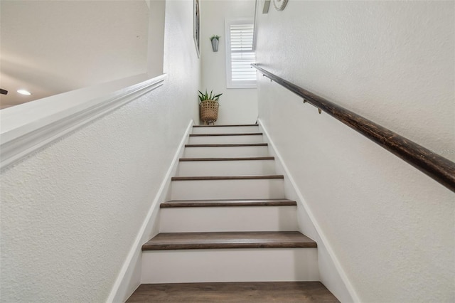 10422 Fenceline Rd, New Port Richey, FL 34655 - stairs featuring a textured wall and wood finished floors