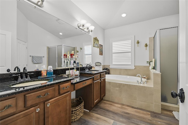 10422 Fenceline Rd, New Port Richey, FL 34655 - bathroom with a shower stall, double vanity, a bath, wood finished floors, and lofted ceiling