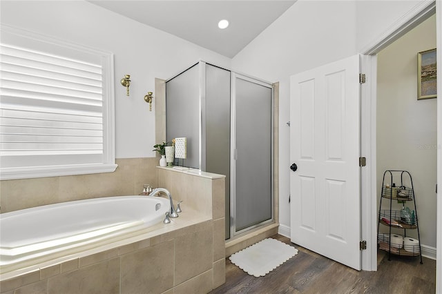 10422 Fenceline Rd, New Port Richey, FL 34655 - bathroom with a garden tub, a shower stall, and wood finished floors