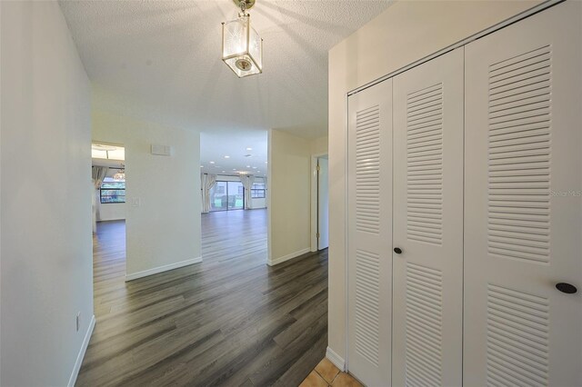 1508 Ingram Dr Unit 20, Sun City Center, FL 33573 - hallway with wood finished floors, a textured ceiling, and baseboards