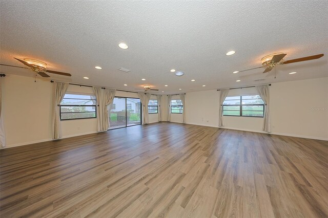 1508 Ingram Dr Unit 20, Sun City Center, FL 33573 - empty room featuring a ceiling fan, a textured ceiling, recessed lighting, light wood-style floors, and baseboards