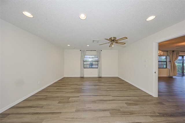 1508 Ingram Dr Unit 20, Sun City Center, FL 33573 - spare room featuring a textured ceiling, a ceiling fan, wood finished floors, recessed lighting, and baseboards
