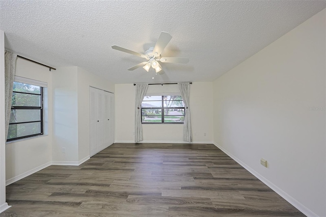 1508 Ingram Dr Unit 20, Sun City Center, FL 33573 - empty room with ceiling fan, dark wood-style flooring, a textured ceiling, and baseboards