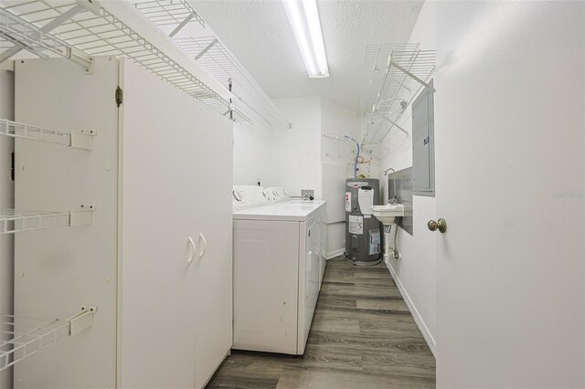 1508 Ingram Dr Unit 20, Sun City Center, FL 33573 - laundry room with washer and clothes dryer, electric water heater, wood finished floors, electric panel, and baseboards