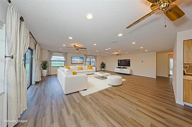 1508 Ingram Dr Unit 20, Sun City Center, FL 33573 - living room featuring ceiling fan, recessed lighting, wood finished floors, baseboards, and a textured ceiling