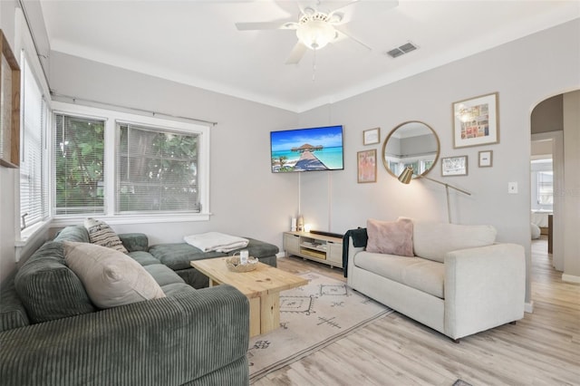 1525 38th Ave N, Saint Petersburg, FL 33704 - living room with arched walkways, ceiling fan, and light wood finished floors