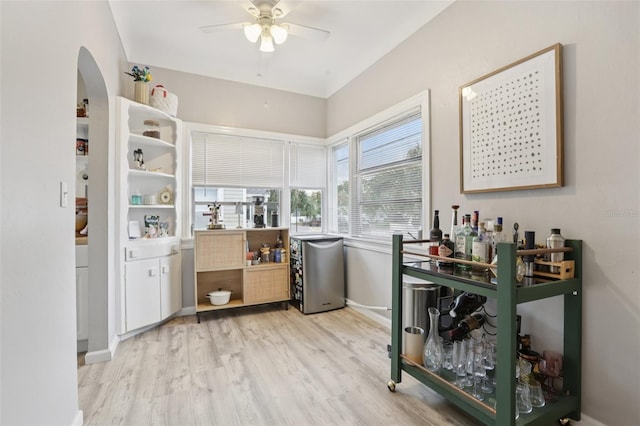 1525 38th Ave N, Saint Petersburg, FL 33704 - bar with arched walkways, a ceiling fan, light wood-style flooring, and baseboards