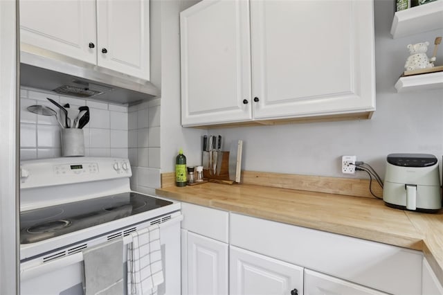 1525 38th Ave N, Saint Petersburg, FL 33704 - kitchen with white electric range oven, decorative backsplash, white cabinets, under cabinet range hood, and wood counters
