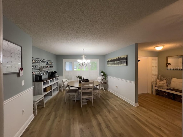 3005 Wilton Ln, Valrico, FL 33596 - dining space with a chandelier, wood finished floors, a textured ceiling, and baseboards