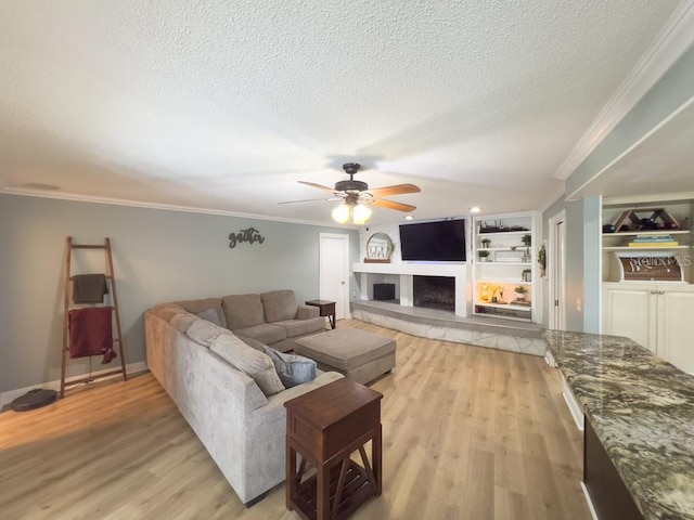 3005 Wilton Ln, Valrico, FL 33596 - living room with a textured ceiling, ceiling fan, ornamental molding, light wood finished floors, and built in shelves