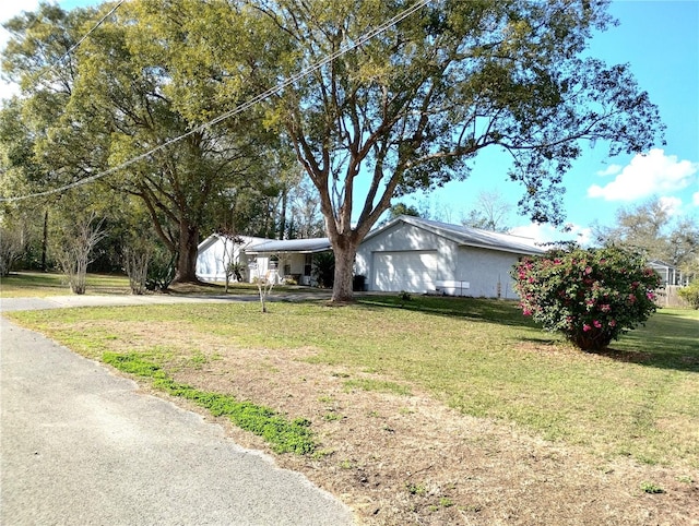 39343/39349 Rusbe, Zephyrhills, FL 33540 - view of front of property featuring an attached garage, a front lawn, and driveway