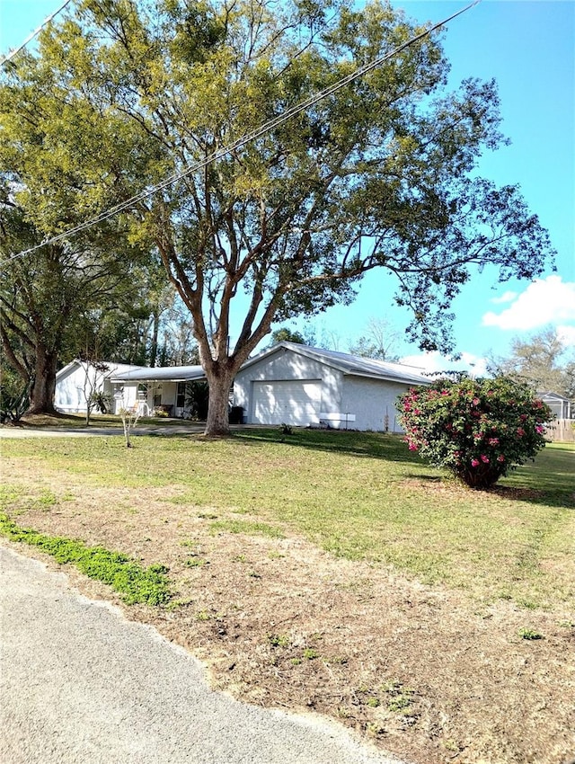 39343/39349 Rusbe, Zephyrhills, FL 33540 - ranch-style home featuring a front lawn and an attached garage