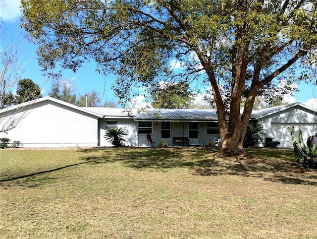 39343/39349 Rusbe, Zephyrhills, FL 33540 - ranch-style house featuring a front lawn, metal roof, a garage, and stucco siding