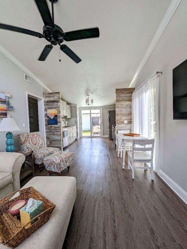 85 Heather Point Ct Unit 850, New Smyrna Beach, FL 32169 - living room with ornamental molding, a ceiling fan, dark wood-type flooring, baseboards, and lofted ceiling
