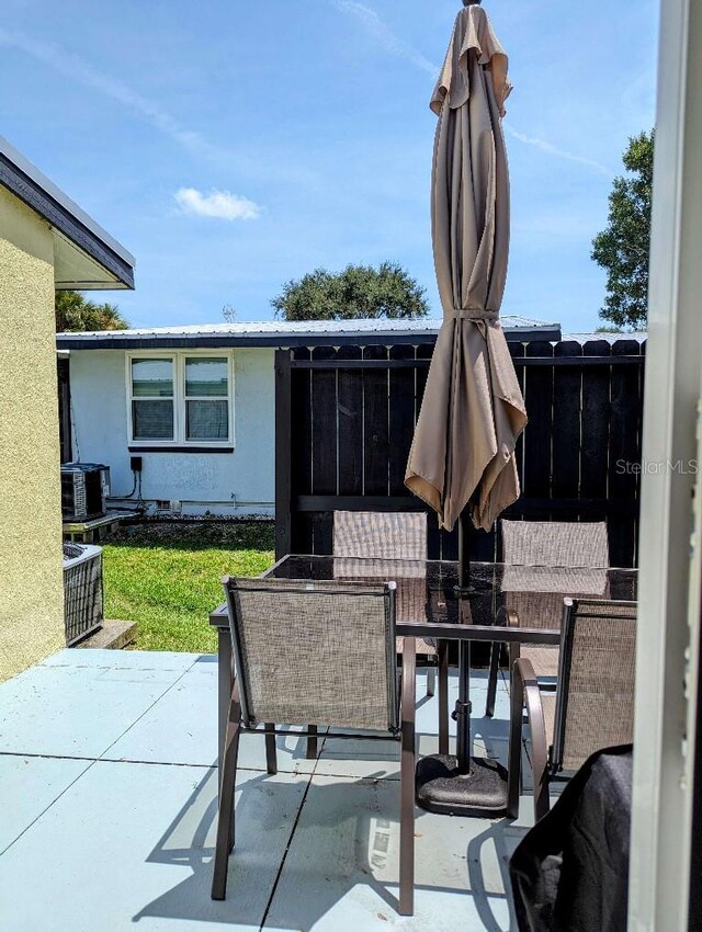 85 Heather Point Ct Unit 850, New Smyrna Beach, FL 32169 - view of patio with outdoor dining space and central AC unit