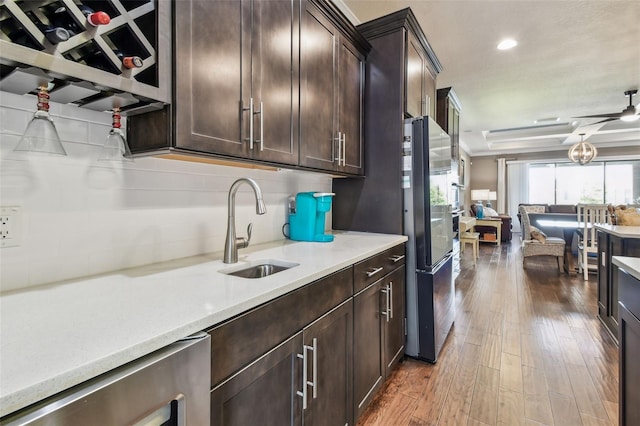 14110 Barrington Stowers Dr, Lithia, FL 33547 - kitchen with a sink, beverage cooler, freestanding refrigerator, wood-type flooring, and light countertops