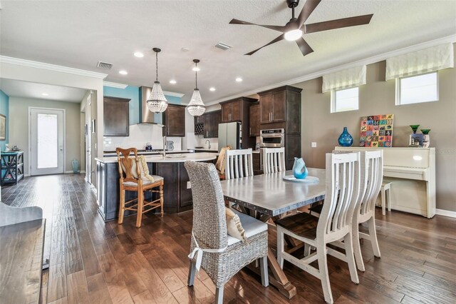 14110 Barrington Stowers Dr, Lithia, FL 33547 - dining room with ceiling fan, crown molding, dark wood finished floors, baseboards, and recessed lighting