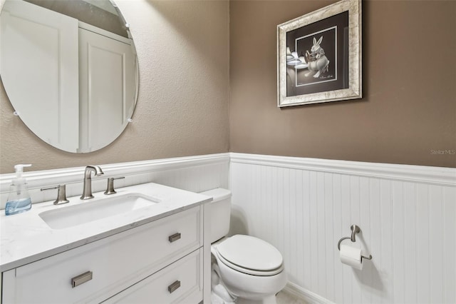 14110 Barrington Stowers Dr, Lithia, FL 33547 - half bathroom featuring wainscoting, toilet, and vanity