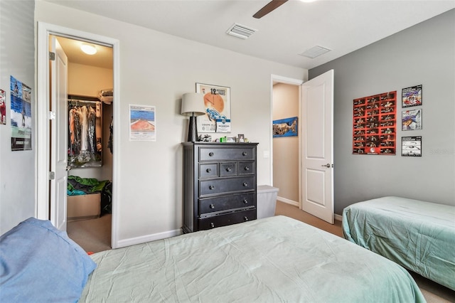 14110 Barrington Stowers Dr, Lithia, FL 33547 - carpeted bedroom with a spacious closet, baseboards, a closet, and a ceiling fan