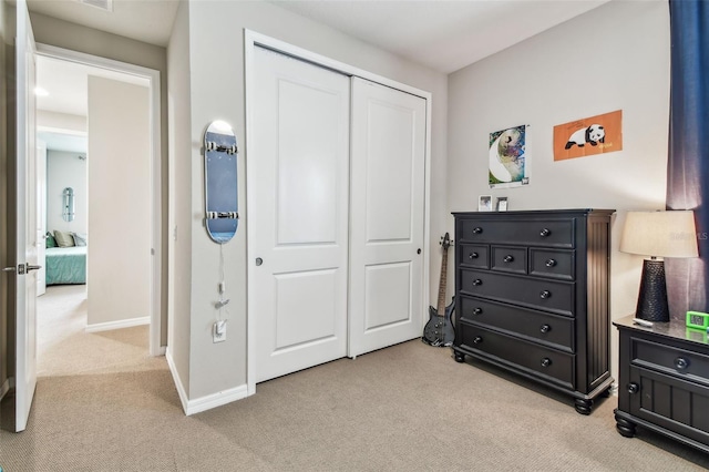 14110 Barrington Stowers Dr, Lithia, FL 33547 - bedroom featuring light carpet, a closet, and baseboards