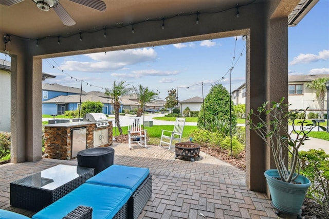 14110 Barrington Stowers Dr, Lithia, FL 33547 - view of patio featuring ceiling fan, an outdoor fire pit, and a residential view