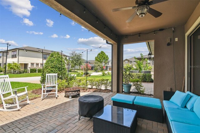 14110 Barrington Stowers Dr, Lithia, FL 33547 - view of patio / terrace featuring an outdoor living space with a fire pit, a residential view, and a ceiling fan