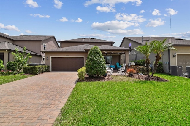 14110 Barrington Stowers Dr, Lithia, FL 33547 - view of front of house featuring decorative driveway, a front yard, stucco siding, an attached garage, and cooling unit