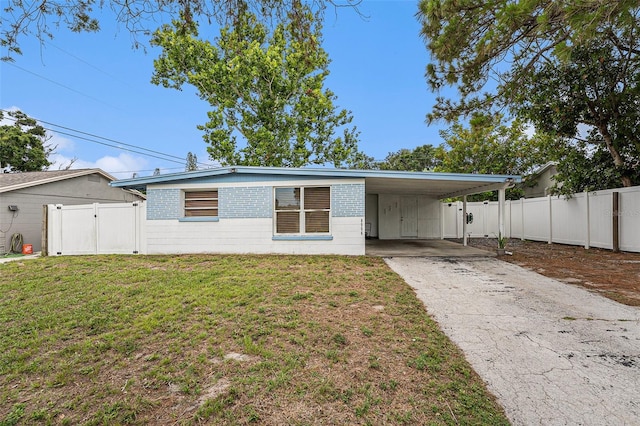 8556 91st Ter, Seminole, FL 33777 - view of front facade featuring driveway, a carport, a gate, and concrete block siding