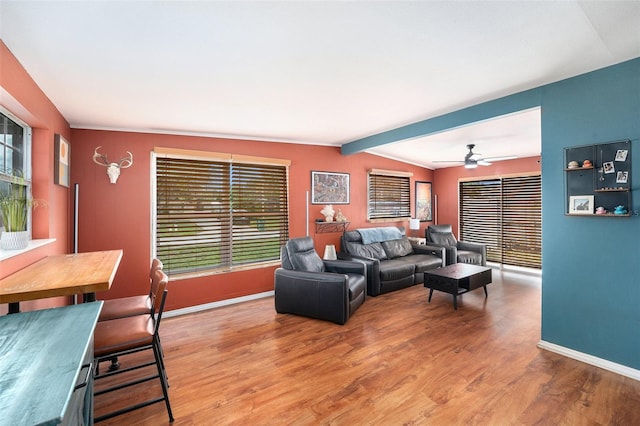 8556 91st Ter, Seminole, FL 33777 - living area featuring plenty of natural light, wood finished floors, and baseboards