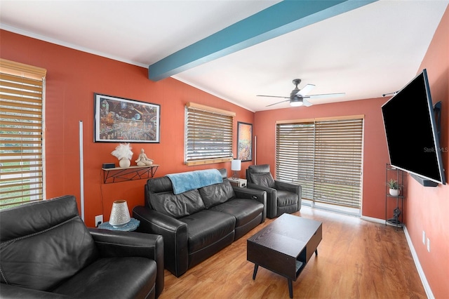 8556 91st Ter, Seminole, FL 33777 - living room featuring light wood-style flooring, ceiling fan, baseboards, and ornamental molding